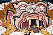 Bangkok Grand Palace, Ramakien murals of the gallery of the Wat Phra Kaew, Hanuman enlarges his body, then places Phra Rams pavilion in his mouth. 